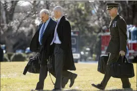  ?? ANDREW HARNIK / ASSOCIATED PRESS ?? President Donald Trump’s Chief of Staff John Kelly (left) and White House Director of Legislativ­e Affairs Marc Short walk toward Marine One on Friday to travel with Trump to Camp David in Maryland.