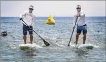  ?? MELANIE BELL / THE PALM BEACH POST ?? Stuart residents Kelly Hilton-Green (left) and Ramsey Small finish their paddle. They left the Bahamas at 12:25 a.m. and the trip took them just over 12 hours.