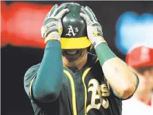  ?? Sean M. Haffey / Getty Images ?? The A’s Ryon Healy is a tad frustrated after a lineout in the ninth inning. Oakland mustered all of three hits.