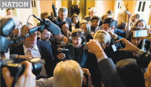  ?? Andrew Harnik / Associated Press ?? Sen. Susan Collins, R-Maine, makes her way through a crush of reporters after Republican senators met with Senate Majority Leader Mitch McConnell, R-Ky., on the GOP effort to overhaul the tax code on Capitol Hill on Friday.