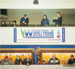  ??  ?? Cowichan Capitals owners Ray Zhang, top right, checks out his team. When he found the BCHL team was for sale, he paid the purchase price of ‘around $1 million.’