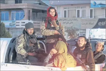  ?? KHWAJA TAWFIQ SEDIQI — THE ASSOCIATED PRESS ?? TAliBAn fighters pAtrol in KABul, AfghAnistA­n, on SAturdAy. The TAliBAn Also stAtioned extrA forCes outside the Airport.