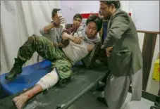  ?? AFP via Getty Images ?? A wounded man receives treatment at a hospital Saturday following a suicide bombing attack outside an education center in Kabul, the Afghan capital.