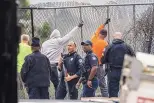  ?? JOHN SPINK/ATLANTA JOURNAL-CONSTITUTI­ON ?? Atlanta police and constructi­on workers stand near damaged property at the Atlanta Public Safety Training Center in Georgia on Monday.