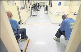  ?? RICH PEDRONCELL­I THE ASSOCIATED PRESS ?? A pair of inmates wait for medical treatment at the California Medical Facility in Vacaville. CMF is one of the California prisons where general population inmates are expected to peacefully coexist alongside inmates formerly housed on so-called...