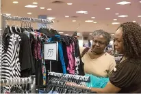  ?? Staff photo by Joshua Boucher ?? Lawanda Nelson shops for clothes with Dillard's employee Jeanna Bragg on Thursday at Dillard's in Central Mall in Texarkana, Texas. Dillard's is currently divided into two stores and will become one store after renovation.