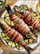  ?? JUSTIN TSUCALAS FOR THE WASHINGTON POST ?? A whole fish for grilled bacon-wrapped trout boosts flavor and helps keep it in one piece as it cooks.