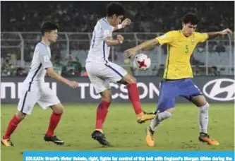  ?? — AP ?? KOLKATA: Brazil’s Victor Bobsin, right, fights for control of the ball with England’s Morgan Gibbs during the FIFA U-17 World Cup semifinal match in Kolkata, India.