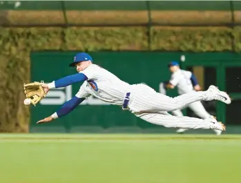  ?? QUINN HARRIS/GETTY ?? Nico Hoerner dives for a ground ball against the Los Angeles Dodgers on Thursday.