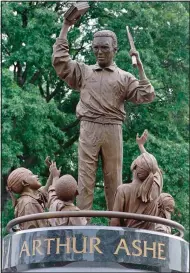  ?? (File Photo/AP/Steve Helber) ?? The statue of Arthur Ashe surrounded by children by sculptor Paul Di Pasquale is unveiled July 10, 1996, on Monument Avenue in Richmond, Va. Grant money will go toward restoratio­n of the Virginia home where tennis coach Dr. Robert Walter “Whirlwind” Johnson helped turn Black athletes such as Ashe into champions.