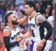  ?? RONALD MARTINEZ / GETTY IMAGES / AFP ?? San Antonio’s Patty Mills (left) and Danny Green celebrate the Spurs’ 110-107 overtime win over the Houston Rockets in Game 5 of their Western Conference semifinal in San Antonio on Tuesday night.