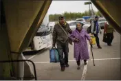  ?? FRANCISCO SECO — THE ASSOCIATED PRESS ?? Kateryna Hodza, 85, and her grandson Artem Dorschenko arrive at a reception center for displaced people in Zaporizhzh­ia, Ukraine, on Friday.