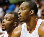 ?? CURTIS COMPTON / CCOMPTON@ AJC.COM ?? The Hawks traded Dwight Howard (right) and a second-round pick to the Hornets for Marco Belinelli, Miles Plumlee and a second-round pick Tuesday.