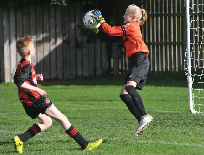  ??  ?? SAFE HANDS: Summer Lawless gathers for Duleek as Conán Fox challenges for Bellurgan during their U-12 Skecher’s Cup clash on Sunday. Picture: Ken Finegan