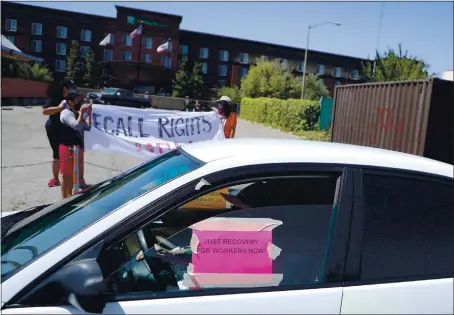  ?? ARIC CRABB — STAFF PHOTOGRAPH­ER ?? Community members take part in a car rally on July 13, in Oakland. The rally was held to support the passage of a city ordinance that would give workers who were laid off during the pandemic a “right to return” if companies start to hire again.