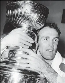  ?? FILE — THE ASSOCIATED PRESS ?? Henri Richard hugs the Stanley Cup after scoring the game-winning goal in overtime to defeat the Detroit Red Wings in Detroit in 1966.