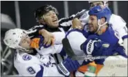  ?? FRANK FRANKLIN II — THE ASSOCIATED PRESS FILE ?? In this file photo, linesman Jay Sharrers, center, tries to break up a fight between Tampa Bay Lightning center Tyler Johnson (9) and New York Islanders center Casey Cizikas (53) during the first period of Game 3of the NHL hockey Stanley Cup Eastern...