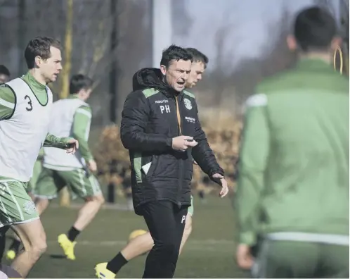  ??  ?? 0 Paul Heckingbot­tom oversees Hibs’ training session yesterday, after which he revealed that Ryan Gauld, below, is not yet ready to return from a hamstring strain.