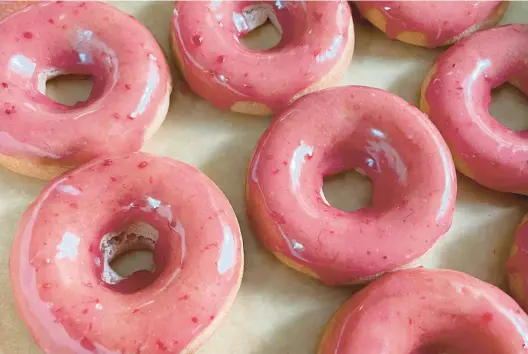  ?? CAITIE MAHARG PHOTOS ?? All the doughnuts from No Nuts Donuts, including these strawberry glazed cake doughnuts, are vegan, nut-free and gluten-free.