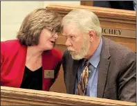  ?? Arkansas Democrat-Gazette/STATON BREIDENTHA­L ?? Rep. Deborah Ferguson talks with Rep. Dan Douglas, R-Bentonvill­e, on Monday in the House chamber after presenting Senate Bill 113, which would fold the Arkansas Health Insurance Marketplac­e into the state’s Insurance Department.