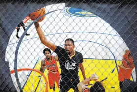  ??  ?? An image of Golden State Warriors forward Kevin Durant is posted outside the Chase Center, under constructi­on in San Francisco’s Mission Bay.