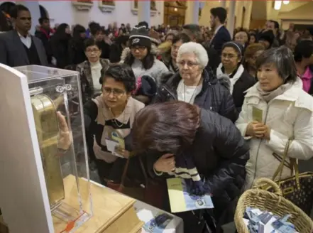  ?? LUCAS OLENIUK/TORONTO STAR ?? Thousands of faithful visited Our Lady of Lourdes Catholic Church in Toronto on Sunday to venerate a relic of St. Francis Xavier.