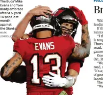  ?? Giants. MARK LOMOGLIO/AP ?? The cs Mike Evans and Tom Brady embrace
ter a 5-yard TD pass last month against the