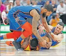  ?? [AP PHOTO/RICK BOWMER] ?? Utah Jazz forward Royce O'Neale, bottom, battles for the ball against Oklahoma City Thunder's Abdel Nader, right, and Markieff Morris during Monday night's game in Salt Lake City. OKC beat the Jazz, 98-89.