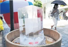  ??  ?? A block of ice is placed at a street in Tokyo.