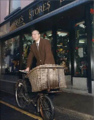  ??  ?? The late Esmond Power pictured with his messenger bike outside Hore’s Stores.