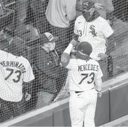  ?? ARMANDO L. SANCHEZ/CHICAGO TRIBUNE ?? White Sox designated hitter Yermin Mercedes (73) takes photos with fans after the home opener at Guaranteed Rate Field on Thursday.