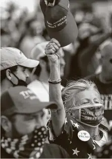  ?? Melissa Sue Gerrits / Getty Images ?? Supporters react to President Donald Trump’s arrival Thursday for a rally at the airport in Greenville, N.C. Thousands gathered to hear him speak.