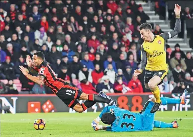  ?? DYLAN MARTINEZ / REUTERS ?? Bournemout­h’s Callum Wilson hits the deck after a tackle by Arsenal goalkeeper Petr Cech, leading to penalty appeals during their English Premier League match at Vitality Stadium in Bournemout­h on Tuesday. The match ended 3-3.