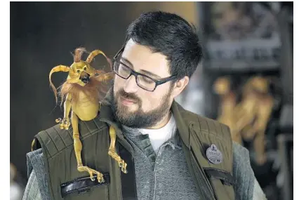  ?? CHRIS PIZZELLO/INVISION/AP ?? A Disneyland employee displays a Kowakian monkey-lizard toy during the Star Wars: Galaxy’s Edge Media Preview at Disneyland in Anaheim.