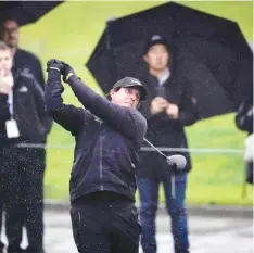  ?? RYAN KANG/THE ASSOCIATED PRESS ?? Phil Mickelson had to restart his round Thursday due to heavy rains at the Genesis Open in Los Angeles.
