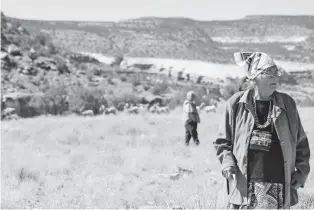  ?? KATHY HELMS/GALLUP INDEPENDEN­T VIA AP ?? Annie Henry and Gilbert Badoni revisit the area where they used to live at the mining camp in Slick Rock, Colo., and found remnants of their former homes. Many Cold War uranium workers, their families and downwinder­s are still waiting, with the deadline fast approachin­g to apply for federal benefits from the Radiation Exposure Compensati­on Act.