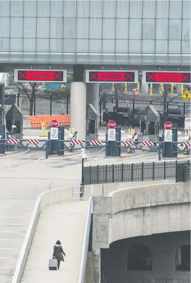  ?? PETER J THOMPSON / NATIONAL POST ?? A pedestrian walks across the Rainbow Bridge in Niagara Falls between Canada and the United States on Wednesday.