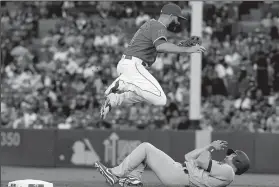  ?? LUIS SINCO/TRIBUNE NEWS SERVICE ?? The Dodgers' Logan Forsythe is safe at second after the throw to Angels second baseman Danny Espinosa, top, is off the mark on Thursday in Anaheim.