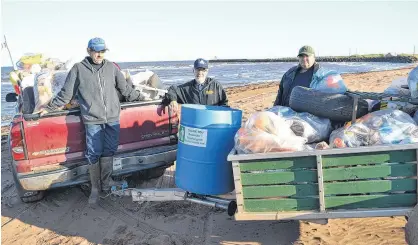  ?? ERIC MCCARTHY/JOURNAL PIONEER ?? Roseville/Miminegash Watersheds Associatio­n Inc. workers, from left, Milton Chaisson, Thane Doucette and Danny Murphy display the debris netted during their September beach sweep.