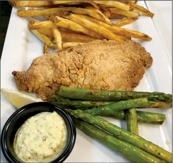  ??  ?? The catfish at Haven 55 is available on Tuesdays and is prepared as one large catfish fillet with two sides available.