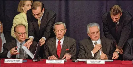  ?? AL BEHRMAN / ASSOCIATED PRESS FILE ?? Then-Secretary of State Warren Christophe­r is flanked by Bosnian President Alija Izetbegovi­c (left) and Croatian President Franjo Tudjman as they sign the Dayton peace accord in this Nov. 10, 1995 photo taken at Wright-Patterson Air Force Base. The settlement created a divided Bosnia-Herzegovin­a, cutting the burgeoning country in segments based upon ethnic and religious affiliatio­n.