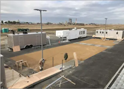  ?? COURTESY ?? Workers construct a ramp to the East Beamer Street homeless housing project. Mobile trailers that provide lavatories, laundry and cooking facilities are also in place at the site.