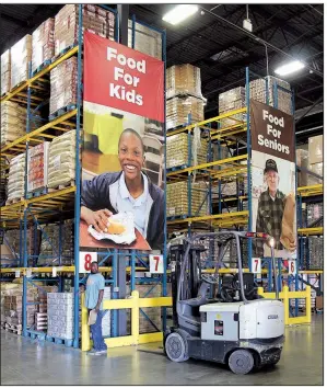  ??  ?? Arkansas Food Bank employee Oliver Lindsey works at the food bank’s warehouse.