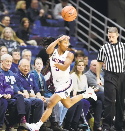  ?? Stephen Dunn / Associated Press ?? UConn’s Crystal Dangerfiel­d (5) looks for an outlet after stealing the ball during the first half of Wednesday’s 82-38 win over Cincinnati.