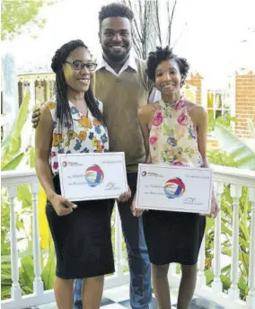  ??  ?? Tafar-i Williams (centre), Total Jamaica 2017 scholarshi­p winner, extends reassuring arms to 2018 recipients Samantha Powell (left) and Gabrielle Buddoo.