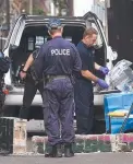  ?? Police tape up evidence after a Surry Hills house was raided. ??