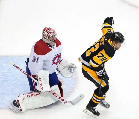  ?? Andre Ringuette/Getty Images ?? A quick fix for the Penguins might be as simple as getting Patric Hornqvist, right, in front of Montreal Canadiens goalie Carey Price and obstructin­g his view of shots.