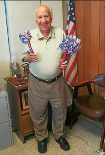  ??  ?? Veteran Sam Coco holds the American flag pinwheels that will be distribute­d by the Delaware County Historical Society and the Delaware County Veterans Memorial Associatio­n at the Marple Newtown Fourth of July parade.