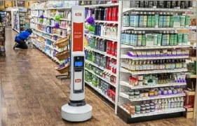  ?? Andrew Rush/ Post- Gazette ?? Giant Eagle is continuing to test new technology in its stores. In this May photo, Tally, an autonomous robot that audits inventory, glides down an aisle at a Fox Chapel Giant Eagle.