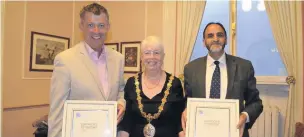  ??  ?? Hyndburn council leader Miles Parkinson and councillor Munsif Dad receive their certificat­es of record from Hyndburn Mayor June Harrison